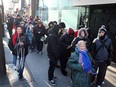 A line stretches down Ouellette Avenue as people wait in line to receive one of 500 free turkeys given away from Mikhail Holdings Ltd. on Dec. 18, 2015.   This is the 10th year MikHail Holdings Ltd. has been proving holiday turkey meals to those in need.