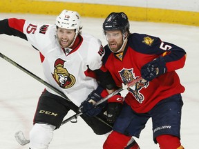 Zack Smith #15 of the Ottawa Senators and Aaron Ekblad #5 of the Florida Panthers battle for position during third period action at the BB&T Center on December 8, 2015 in Sunrise, Florida. The Senators defeated the anthers 4-2. (Photo by Joel Auerbach/Getty Images)