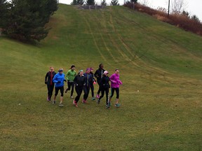 In this file photo, Windsor Legion track team run on the first day of winter at Malden Park toboggan hill Monday, Dec. 21, 2015. Beautiful green grass and clear trails for the runners.