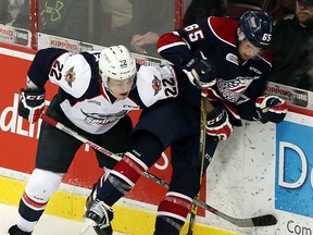 The Windsor Spitfires Brendan Lemieux checks the Saginaw Spirits Will Petschenig at the WFCU Centre in Windsor on Thursday, December 17, 2015.               (TYLER BROWNBRIDGE/The Windsor Star)