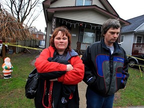 Jennifer and Gord Drummond stand in front of their home at 3666 Queen St. on Monday, Dec. 21, 2015.  A fire caused extensive damage to their home.