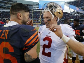 San Francisco 49ers quarterback Blaine Gabbert (2) talks to Chicago Bears tight end Zach Miller (86) after an NFL football game, Sunday, Dec. 6, 2015, in Chicago. The 49ers won 26-20. (AP Photo/Charles Rex Arbogast)