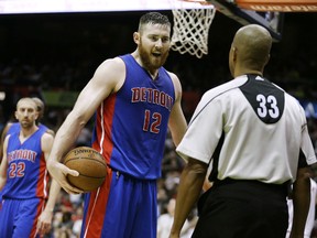 Detroit Pistons' Aron Baynes, center, argues a call with official Sean Corbin in the second quarter of an NBA basketball game against the Atlanta Hawks Wednesday, Dec. 23, 2015, in Atlanta. The Hawks won 107-100. (AP Photo/David Goldman)