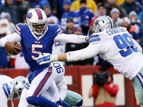 Windsor's Tyrone Crawford, right, tries to tackle Buffalo quarterback Tyrod Taylor during the second half of the Cowboys-Bills game at Ralph Wilson Stadium Sunday in Orchard Park, New York.  (Photo by Tom Szczerbowski/Getty Images)