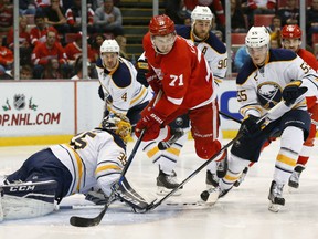 Detroit Red Wings center Dylan Larkin (71) jumps over Buffalo Sabres goalie Linus Ullmark (35) in the second period of an NHL hockey game Tuesday, Dec. 1, 2015 in Detroit. (AP Photo/Paul Sancya)