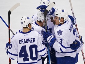 Toronto Maple Leafs' Dion Phaneuf (3) celebrates his goal with teammates during the first period of an NHL hockey game against the Pittsburgh Penguins in Pittsburgh, Wednesday, Dec. 30, 2015. (AP Photo/Gene J. Puskar)