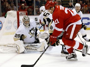 Pittsburgh Penguins goalie Marc-Andre Fleury (29) prepares to stop a shot by Detroit Red Wings left wing Tomas Tatar (21), of Slovakia, in the second period of a NHL preseason hockey game in Detroit Wednesday, Oct. 1, 2014. (AP Photo/Paul Sancya)