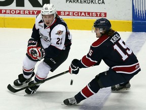 The Windsor Spitfires Brendan Lemieux flips the puck past the Saginaw Spirits Matthew Kreis at the WFCU Centre in Windsor on Thursday, December 17, 2015.               (TYLER BROWNBRIDGE/The Windsor Star)