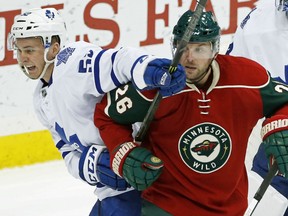 Minnesota Wild’s Thomas Vanek right, of Austria, gets a glove on the stick of Toronto Maple Leafs' Martin Marincin, of Slovakia, during the first period of an NHL hockey game, Thursday, Dec. 3, 2015, in St. Paul, Minn. (AP Photo/Jim Mone)
