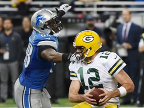 Detroit Lions defensive end Devin Taylor (98) reaches in on Green Bay Packers quarterback Aaron Rodgers (12) and is called for a face mask during the second half of an NFL football game, Thursday, Dec. 3, 2015, in Detroit. (AP Photo/Melanie Maxwell/The Ann Arbor News/Mlive.com via AP)