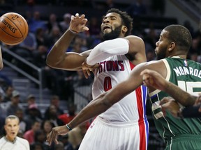 Detroit Pistons’ Andre Drummond (0) has the ball knocked away by Milwaukee Bucks' Greg Monroe (15) during the first half of an NBA basketball game Friday, Dec. 4, 2015, in Auburn Hills, Mich. The Pistons defeated the Bucks 102-95. (AP Photo/Duane Burleson)