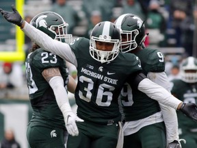 Windsor's Arjen Colquhoun (36), Chris Frey (23) and Montae Nicholson celebrate a play during the fourth quarter of an NCAA college football game against Purdue in East Lansing, Mich. (AP Photo/Al Goldis, File)