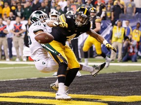 Tevaun Smith #4 of the Iowa Hawkeyes misses a catch while being defend by Arjen Colquhoun #36 of the Michigan State Spartans in the Big Ten Championship at Lucas Oil Stadium on December 5, 2015 in Indianapolis, Indiana.  (Photo by Joe Robbins/Getty Images)