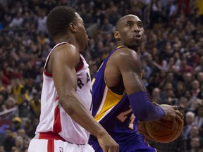 Los Angeles Lakers' Kobe Bryant, right, drives past Toronto Raptors' Kyle Lowry during second half NBA basketball action in Toronto on Monday, December 7, 2015. THE CANADIAN PRESS/Chris Young