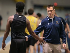 Coach Brett Lumley (R) congratulates an athlete during the annual Blue and Gold track meet at the University of Windsor on Monday, December 7, 2015. (DAN JANISSE/The Windsor Star)