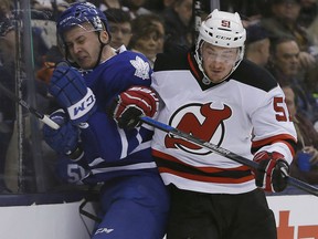 New Jersey Devils forward Sergey Kalinin (51) takes Toronto Maple Leafs defenceman Martin Marincin (52) into the boards during the first period at the Air Canada Centre. Mandatory Credit: John E. Sokolowski-USA TODAY Sports