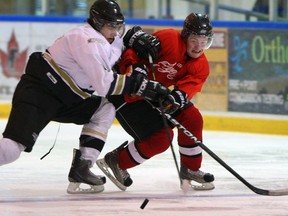 Vipers Nick Crescenzi, left, slows down Flyers Cale Allen in first period Junior B exhibition action from Vollmer Centre August 21, 2013. (NICK BRANCACCIO/The Windsor Star)