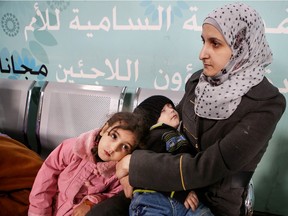 A Syrian refugee woman waits at the registration office at the UNHCR Headquarters in Amman, Jordan, Wednesday, Dec. 2, 2015. Canada has launched a fast-track resettlement program for Syrian refugees that the nation's ambassador to Jordan says could serve as a model for other countries.