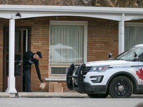 Police investigate an overnight assault at the Travellers Choice motel on Sandwich Street on Friday, Dec. 25, 2015.
