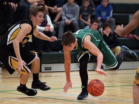 Brett Vandermuren (L) of Amherst and Michael Mutter of Belle River battle for the ball during their game on Friday, Dec. 11, 2015, in Belle River, Ont.