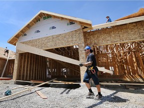 Joel Parent, below, and his co-workers are shown at the construction site of a home in the 2200 block of Gatwick Avenue on Friday, Aug. 7, 2015, in Windsor, Ont.