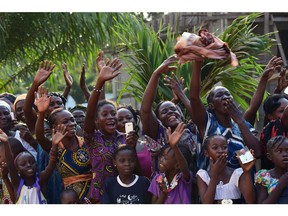 People reacts during the visit of Pope Francis at  the Evangelic community  in Bangui on November 29, 2015. Pope Francis arrived as "a pilgrim of peace" in conflict-ridden Central African Republic on November 29, flying in from Uganda on what will be the most dangerous destination of his three-nation Africa tour.