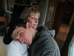 Michelle Jones-Rousseau hugs her son Kyle as he prepares to leave the house with a support worker in this file photo.