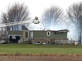 Lakeshore firefighters battle a house fire on County Rd. 31 near County Rd. 8 in Lakeshore on Dec. 21, 2015.