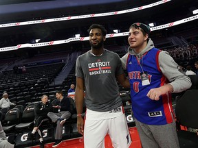 David Younan meets with the Detroit Pistons Andre Drummond before their game against the Los Angeles Clippers at the Palace of Auburn Hills on Monday, Dec. 14, 2015. Younan watched the team warm ups court side and had the chance to meet several players.
