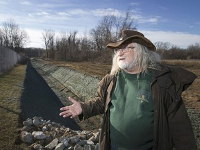 Joe McIntosh, a concerned resident, discusses a trench that was dug in Broadway Park, next to Black Oak Heritage Park in West Windsor, Friday, Dec. 11, 2015.  The trench borders the property of the Dainty Plant on Broadway Street.