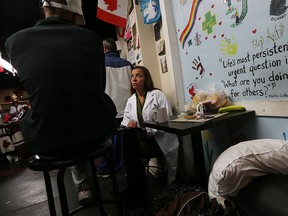 Elizabeth Haramic talks with John Anderson during a visit from medical doctors at Street Help in Windsor on Friday, Dec. 18, 2015. Doctors and therapists visited with patients and will provide follow up help as will.