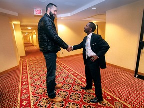 Windsor Express CEO Dartis Willis (R) greets Ljubisa Vrcelj at a team orientation meeting Wednesday, December 9, 2015, at the Holiday Inn in Windsor, ON. Vrcelj, a former W. F. Herman Secondary School graduate will be a training camp with a number of other hopefuls from Canada and the U.S.