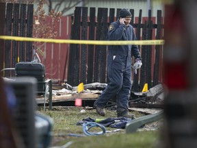 An investigator with the Office of the Ontario Fire Marshal works at the scene of a shed explosion at 3384 Hemlock Rd., Sunday, December 6, 2015.  Two people were sent to hospital with unknown injuries.