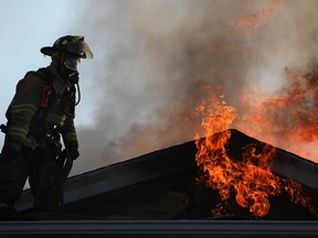 A firefighter battles a blaze on the 1000 block of Albert Road in Windsor in this file photo.