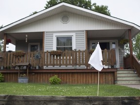 A white flag is placed on the lawn of a home on Edinborough Street in Remington Park in this June 2015 file photo. The white flag campaign, conducted by Windsor Essex Right to Know, is in response to the cancer cluster discovery in the area.