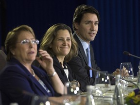 Prime Minister Justin Trudeau, right, sits beside Minister of International Trade Chrystia Freeland as they take part in a Trans-Pacific Partnership meeting on the side-lines of the APEC Summit in Manila, Philippines on Wednesday, Nov. 18, 2015.