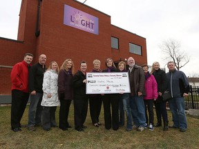 The executive board and the women's committee from Unifor 444 present a cheque to Hiatus House in the amount of $13,401.00 at Hiatus House in Windsor on Thursday, Dec. 10, 2015. The money was raised by the selling of purple scarves during the Shine the Light campaign.