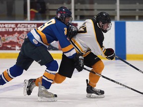 Kennedy's Joshua Ewanski (L) and Riverside's Kyle Glover race for the puck during their game on Monday, December 7, 2015, at the WFCU Centre in Windsor, ON. (DAN JANISSE/The Windsor Star)