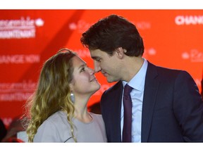 In this file photo, Prime Minister Justin Trudeau stands on stage with his wife Sophie Gregoire  following his speech at a Liberal party function.