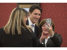 Women pose for a selfie with Prime Minister Justin Trudeau as he greets them prior to a meeting with national aboriginal organizations on Parliament Hill in Ottawa, Wednesday December 16, 2015.