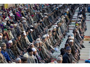 Kashmiri Muslims offer prayers on a road outside the shrine of Sufi saint Khwaja Naqashbandi in Srinagar, Indian controlled Kashmir, Tuesday, Dec. 15, 2015. Thousands of Kashmiri Muslims congregated at the shrine on the death anniversary of the saint and offered prayers in a three-day festival that concluded Tuesday.