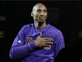 Los Angeles Lakers forward Kobe Bryant acknowledges the fans during player introductions of an NBA basketball game against the Detroit Pistons, Sunday, Dec. 6, 2015, in Auburn Hills, Mich.