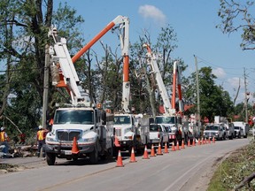 Hydro One crews replace utility poles along Seacliff Drive in Leamington, Ont. during efforts to restore power to the southwestern Ontario town.