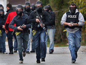 The Windsor Police Service held a training exercise on Thursday, Nov. 6, 2014, to simulate a live shooter situation at a school. Officers move towards the conflict during the exercise.