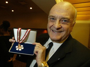 Howard Pawley holds up his Order of Canada medal Wednesday night prior to a ceremony honouring the achievement at the University of Windsor CAW Centre. In addition to being the former premier of Manitoba, Pawley is a Professor Emiritus in Politicla Science and Law at the university.