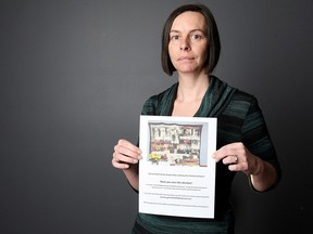Jessica Gerard holds a poster displaying a treasured quilt adorned with family photos that may have been mistakenly donated to an area thrift store. Gerard is pictured at the Windsor Star on Dec. 10, 2015.