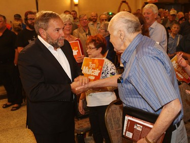 NDP federal leader Tom Mulcair shakes hands with  Howard Pawley, former premier of Manitoba,  during his stop at the Fogolar Furlan Club in Windsor, Ontario on July 22, 2015.