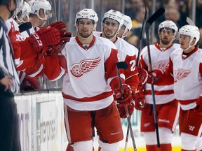 Detroit Red Wings defenseman Xavier Ouellet, facing left, celebrates his goal with teammates during the second period of a preseason NHL hockey game against the Boston Bruins in Boston, Saturday, Oct. 4, 2014.