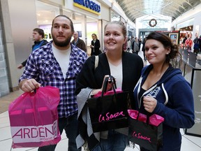 Adam Barron, Crystal Barron, and Sarah Santarossa complete some last-minute shopping at Devonshire Mall on Wednesday, Dec. 23, 2015.