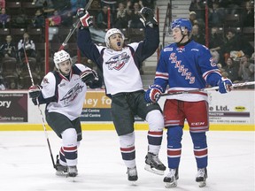 Windsor's Cristiano DiGiacinto and Cole Carter, left, celebrate DiGiacinto's first-period goal while Kitchener's Darby Llewellyn looks on during OHL action at the WFCU Centre, Sunday, Dec. 13, 2015.